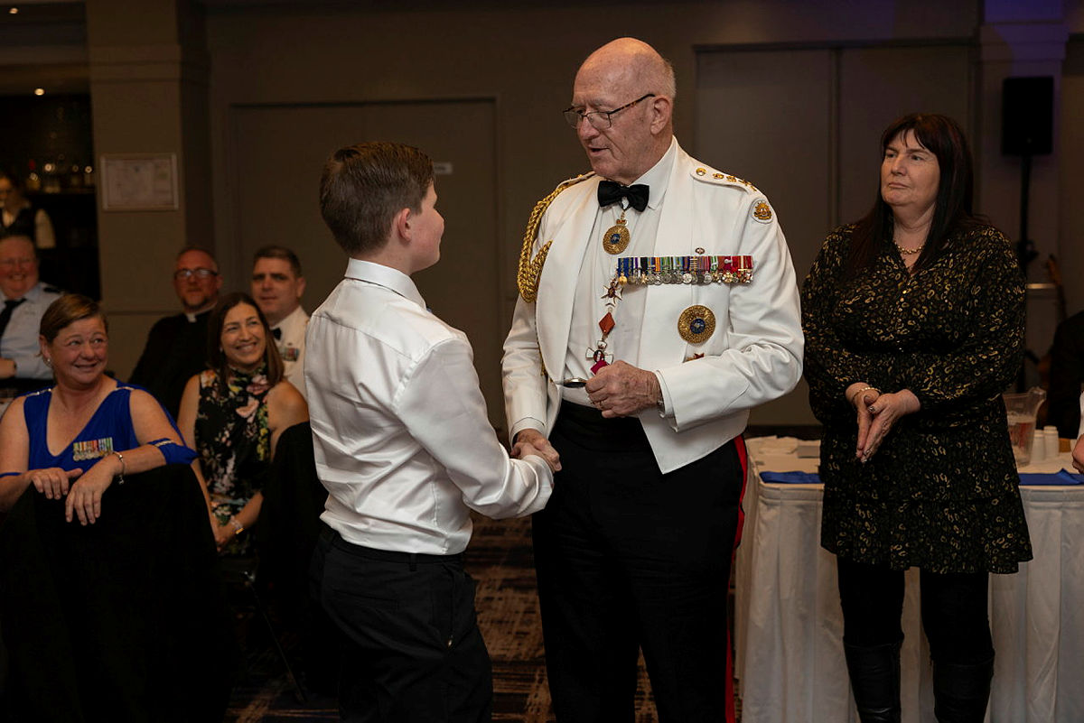 Sir Peter Cosgrove presents the Patron coin to a cadet at the 340 (City of Griffith) Squadron and 223 Army Cadets Unit (Leeton) annual joint dining-in-night.